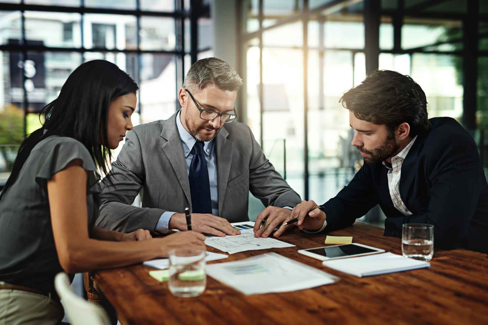 Image of a meeting in progress, with individuals collaborating in a professional setting. Text overlay features '411 Immigration Law' and 'Appeal Processes for Denied Applications,' emphasizing support and guidance for navigating application appeals.