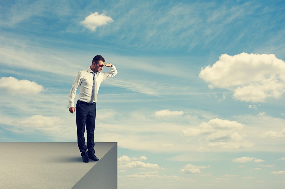 Image of a man standing on the edge and looking down, featuring 411 Immigration Law and highlighting Avoiding Common Pitfalls, ensuring it aligns with the page's context.