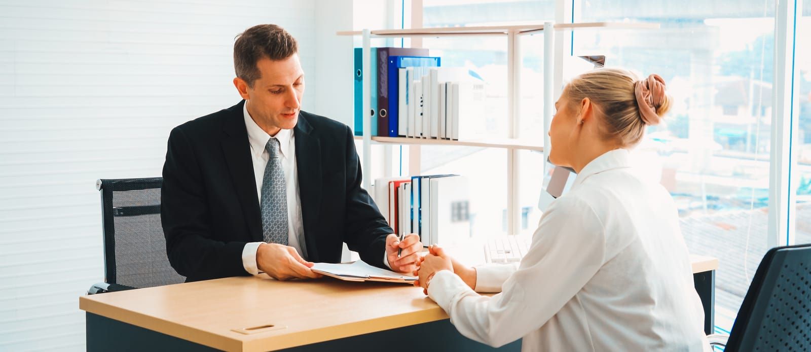 Image of a professional interview setting, with two individuals engaged in conversation. Text overlay features '411 Immigration Law' and 'Interview and Evaluation,' emphasizing expert guidance in assessing immigration cases.