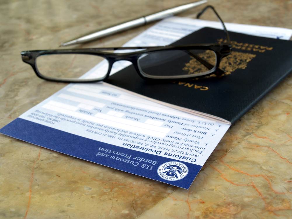 Image of a passport on a U.S. declaration card, featuring 411 Immigration Law and highlighting Why Do You Need an Immigration Lawyer for Investor Visas?, ensuring it aligns with the page's context.