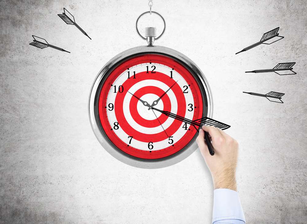 Image of a man aiming a dart at a clock, featuring 411 Immigration Law and highlighting Timelines and Expectations, ensuring it aligns with the page's context.